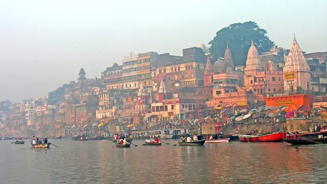 Rowing boats below the ghats in the morning light, Varanasi
